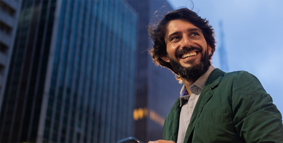 Man smiling using phone